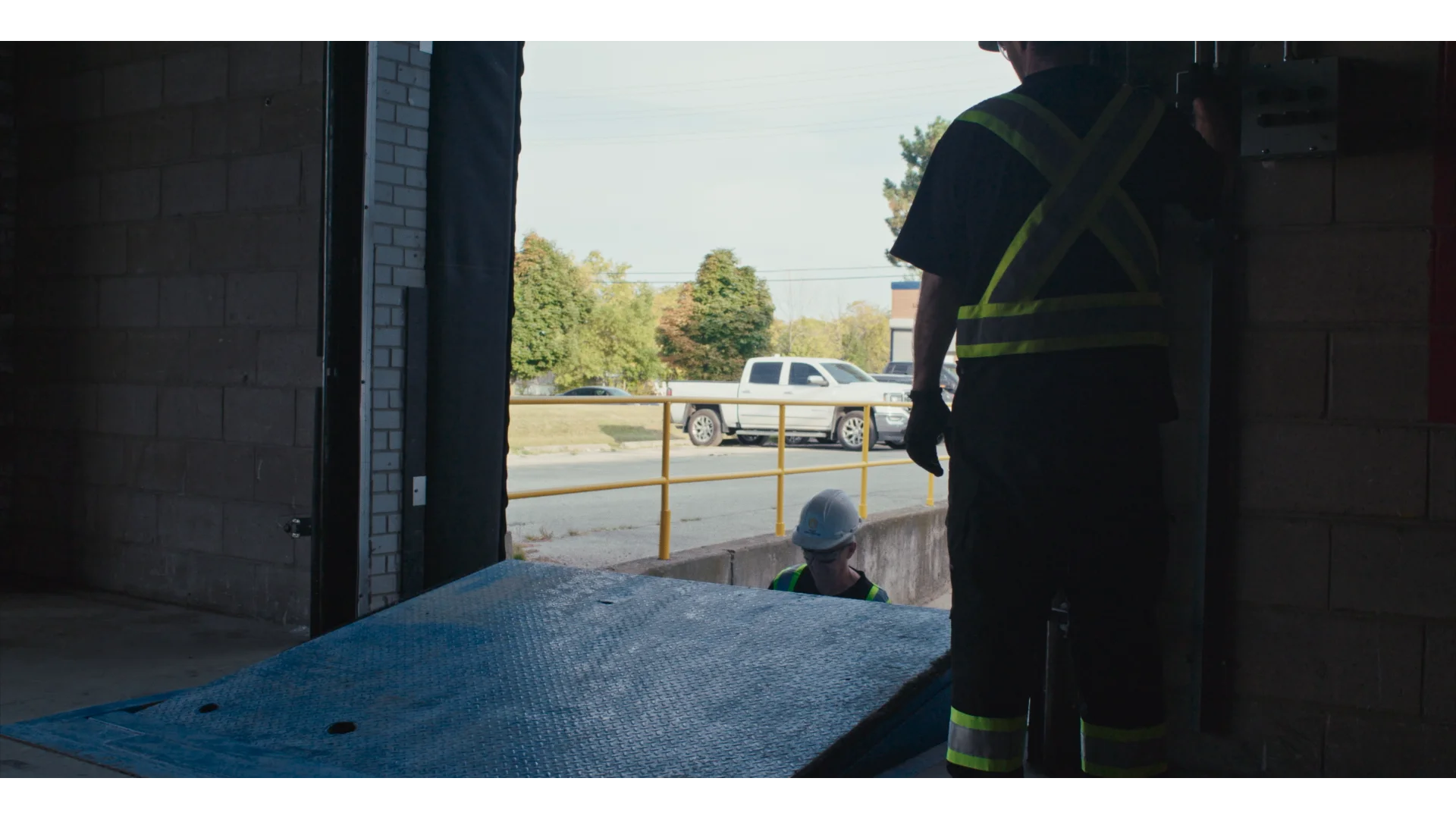 A technician performing commercial door repairs.
