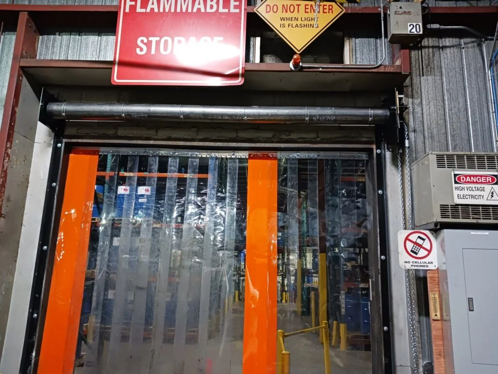 Wilcox technician replacing a coiling fire door at a chemical distribution facility
