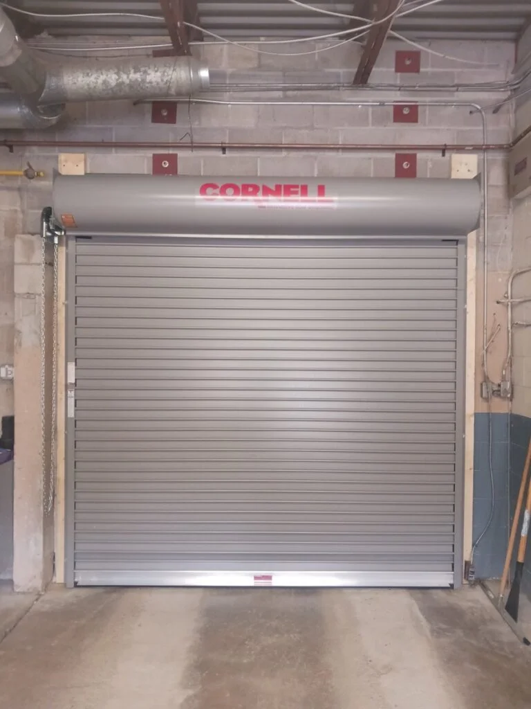 Rolling steel door in its guides during a Wilcox replacement