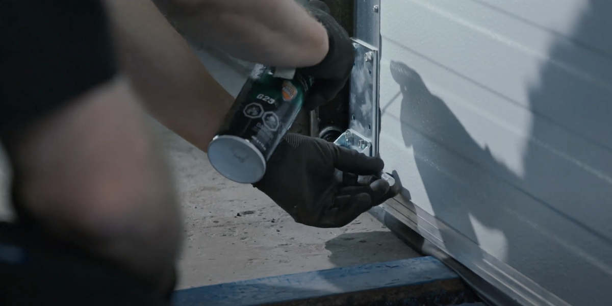 Wilcox technician doing maintenance on a loading dock door