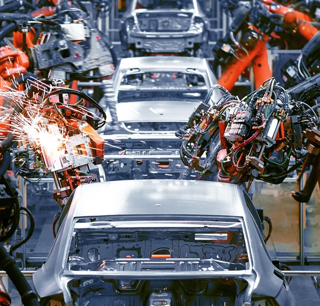 Machines building cars on a conveyor belt