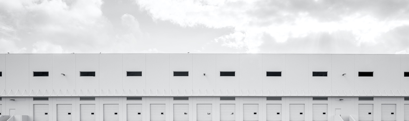 Wide shot of a large commercial doors & dock warehouse exterior