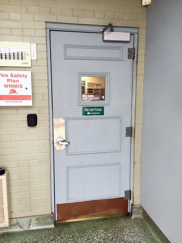 grey wood man door with reception sign on front