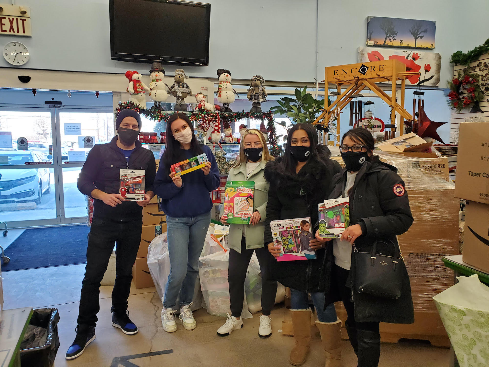 Wilcox team members giving gifts to charity for toy drive