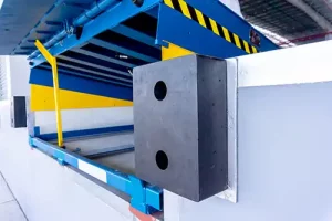 Loading dock leveler with safety bumpers