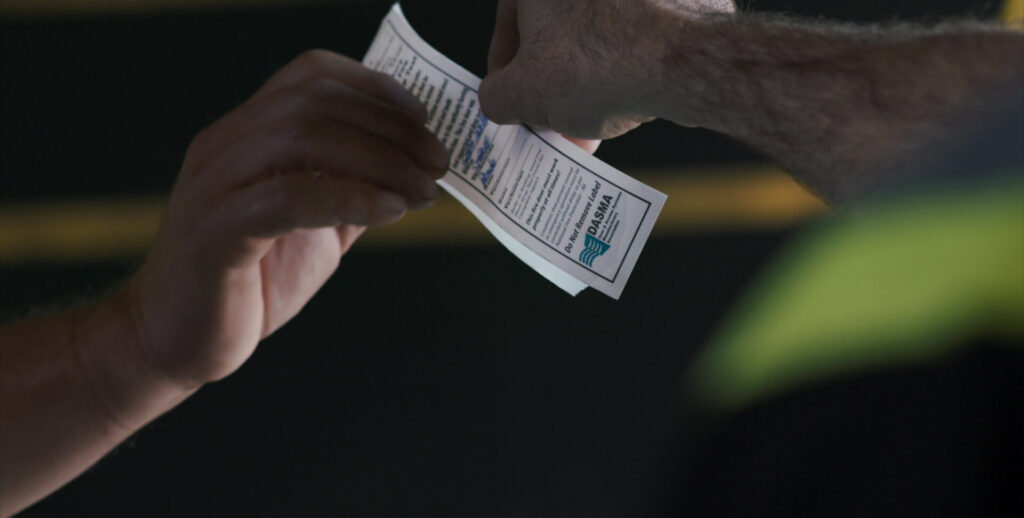 wilcox technician handing completed safety inspection label to customer