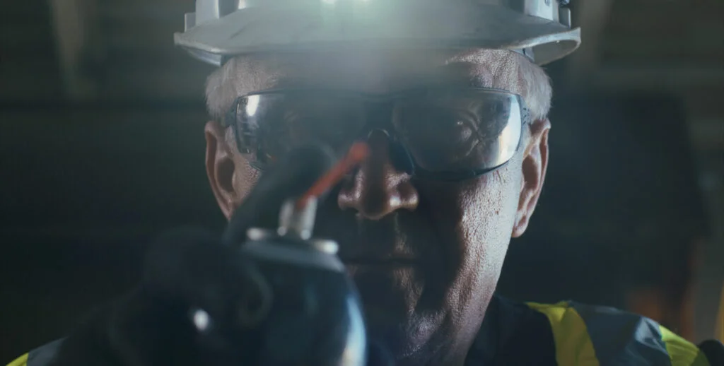Wilcox technician wearing a headlamp conducting a safety inspection