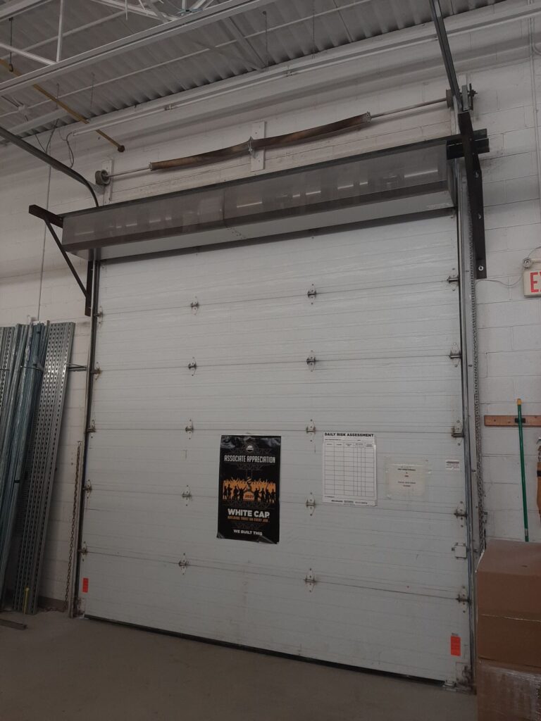 Insulated Sectional Door & Air Curtain Installation — White Cap Distribution, Concord
