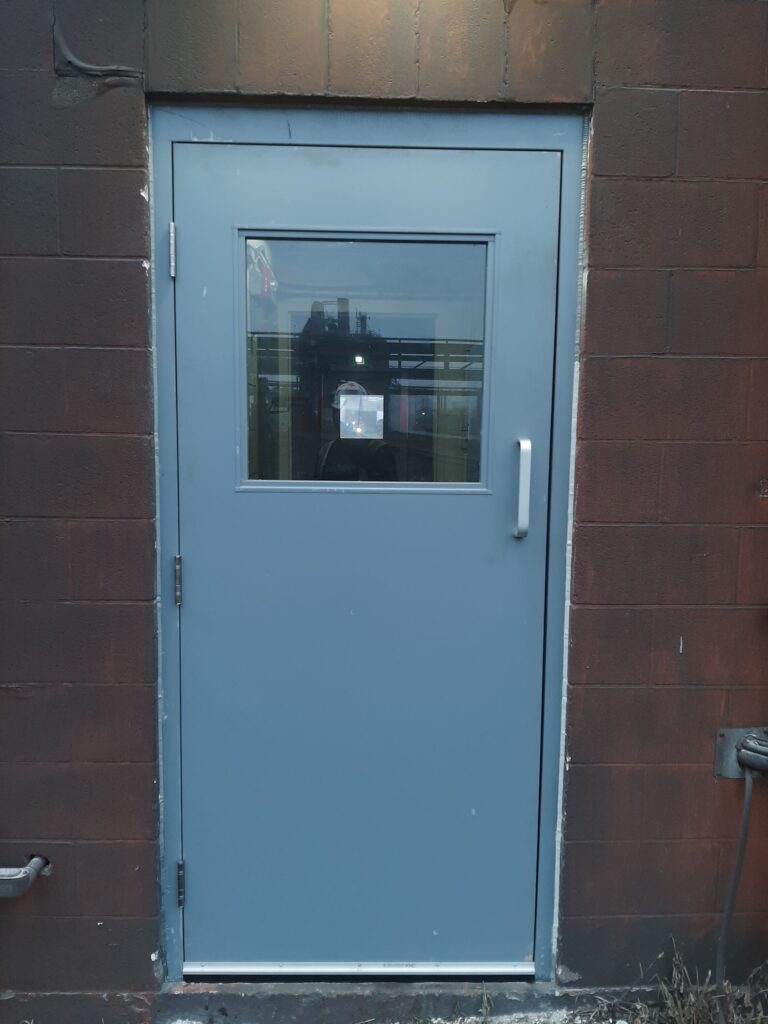 Hollow Metal Personnel Door with Vision Panel — Industrial Plant Interior, Brampton